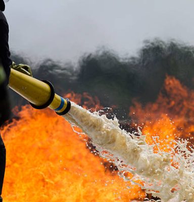 Fire-fighters applying foam to a fire. Fire-fighters applying foam to a fire.