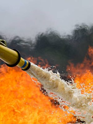 Fire-fighters applying foam to a fire.